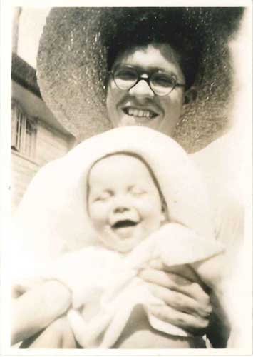 Photograph of Fred with his new son Geoff in 1944