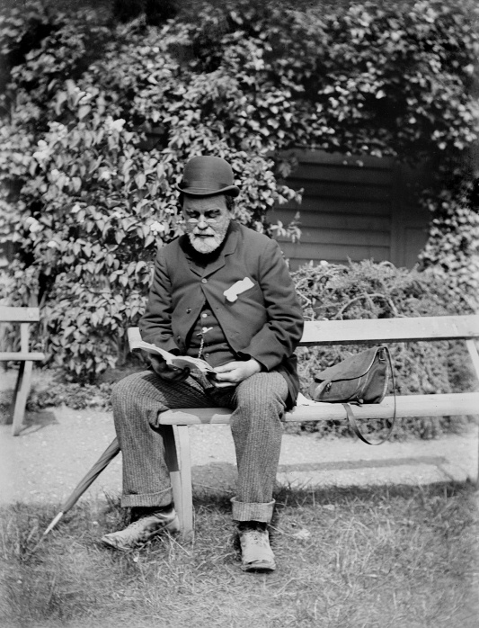 Photograph of Samuel Butler on a bench reading