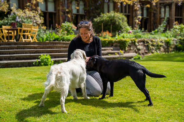 ​  Victoria with her puppy Roxy the golden retriever, and Folly, the black labrador belonging to Heather Hancock, the Master. 