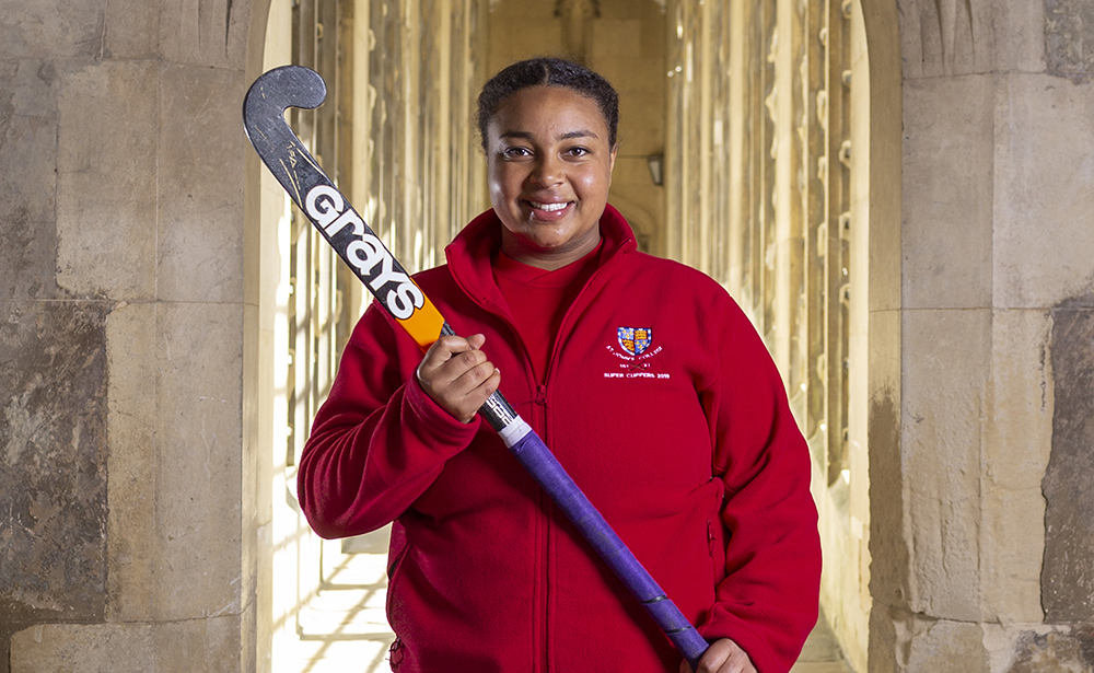 A student with a hockey stick