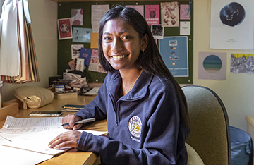 A student studies in her room