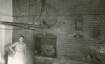 Bill Daish in front of College bakehouse oven by Ken North (1930s)