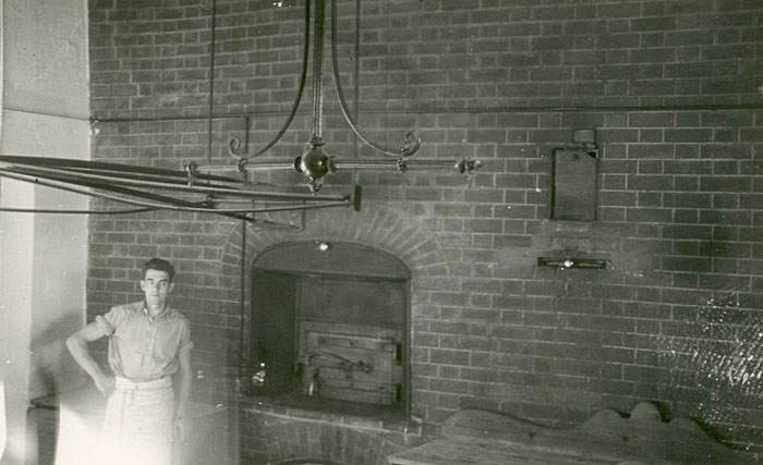 Bill Daish in front of College bakehouse oven by Ken North (1930s)