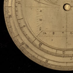 Part of the back of the same astrolabe.  The letters L, S, and S near the edge stand for Libra, Scorpio, and Saggitarius.  The letters S, O, N, and D stand for September, October, November, and December. Image © Whipple Museum of the History of Science, University of Cambridge.