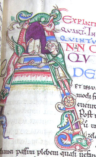 A page from a manuscript showing a dragon giving a book to a man.