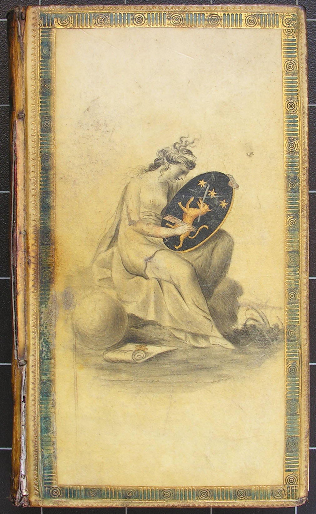 A book bound in painted vellum, illustrated with a woman looking at a shield.