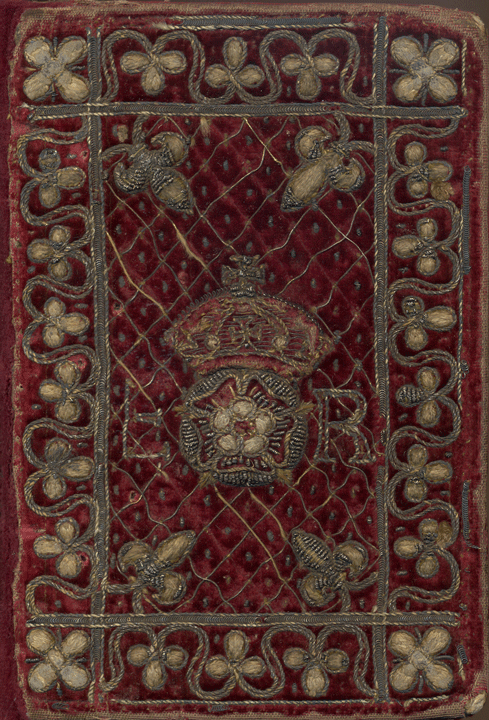 A book bound in red velvet with metal thread decoration including a Tudor rose and the initials E R.