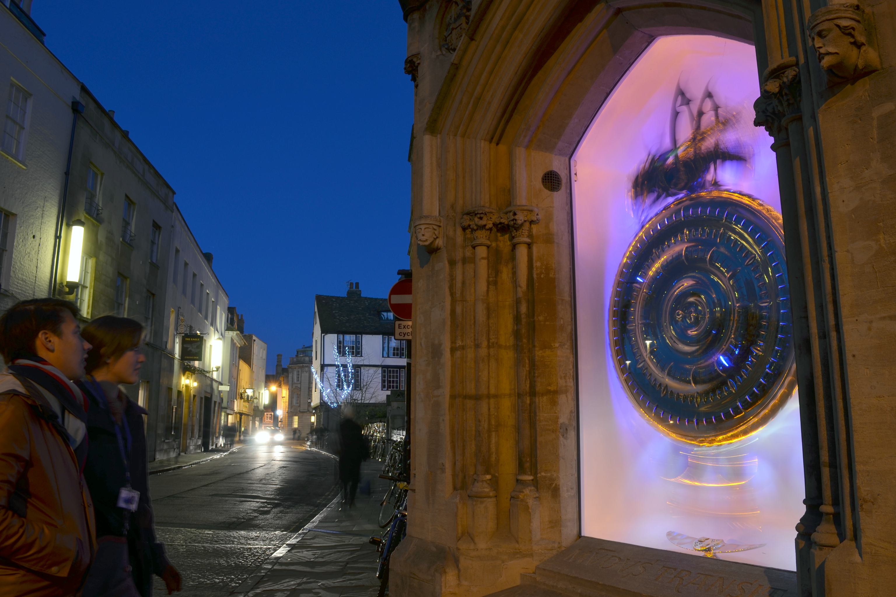 Two people look at the Choronphage clock of Corpus Christi