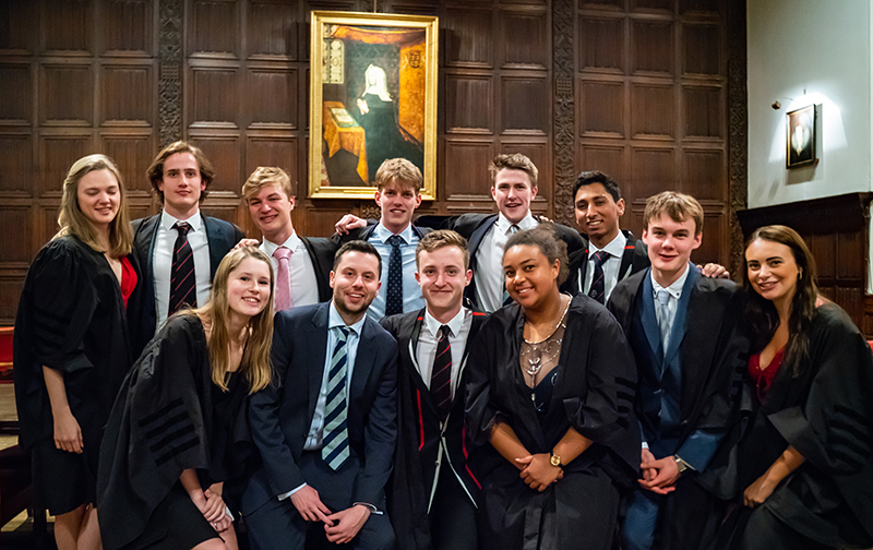 Students pose in front of Lady Margaret's portrait