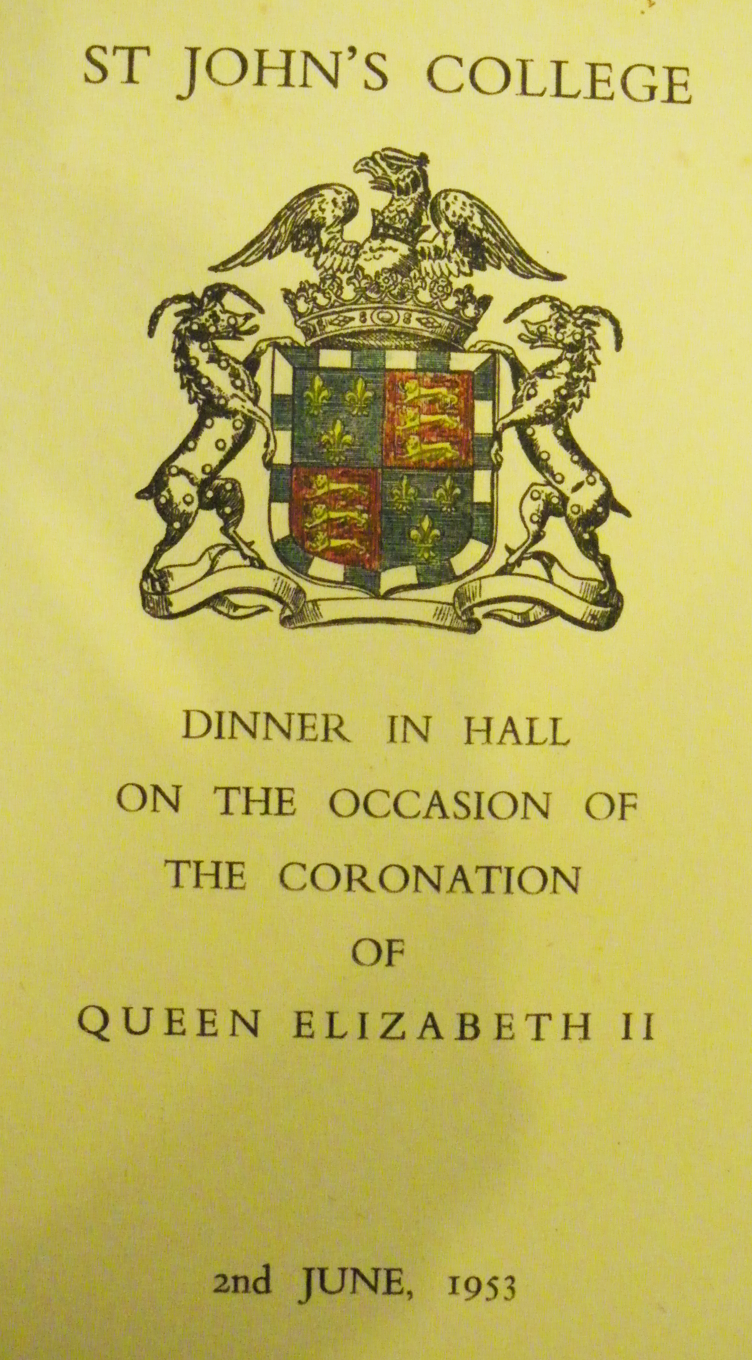 A dinner menu with the college crest.