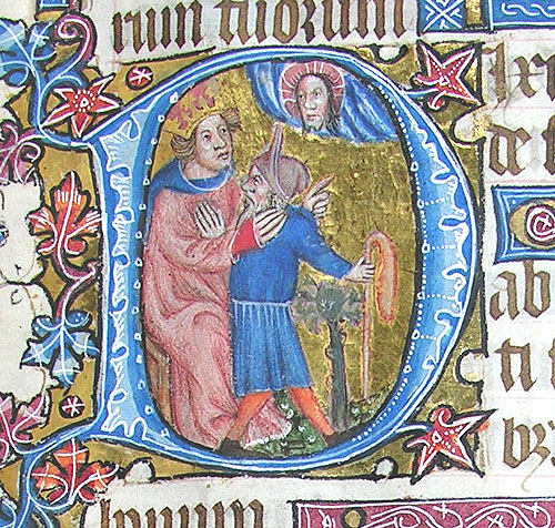 A large capital D in blue against a gold background, with blue and red foliage growing off it. Within the D, a king in red faces a fool in blue (who is holding a red bladder on a stick); above the fool, God, at whom the King points, is visible. 