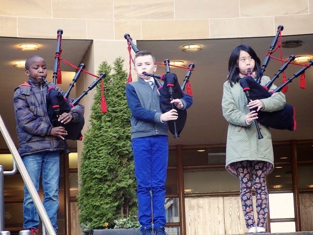 Dami playing the bagpipes with friends