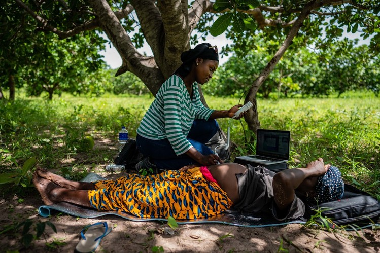 A scientist and pregnant woman in The Gambia