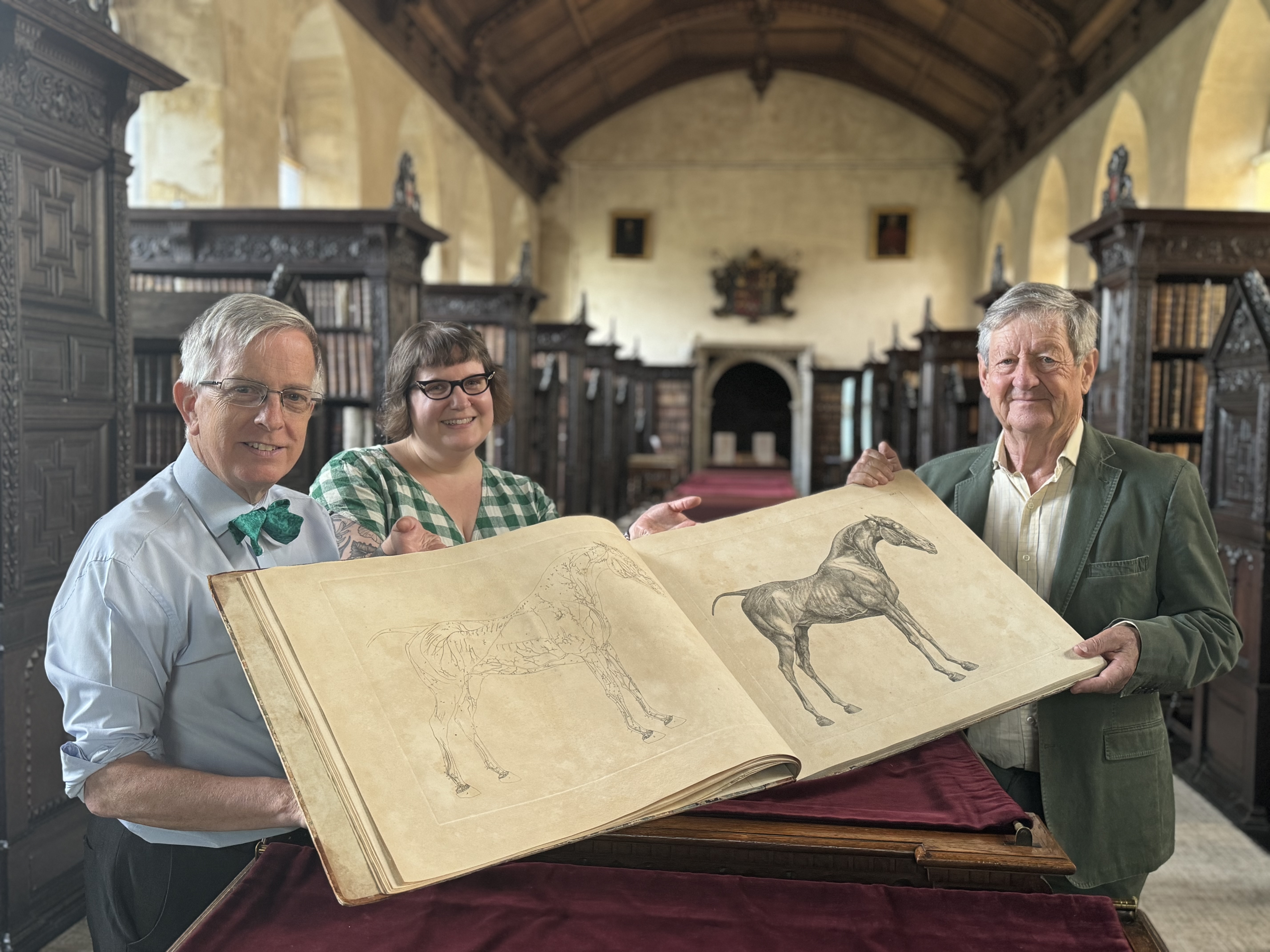 Dr David Williams, Tanya Kirk and Philip Paxman with the Stubbs book in the Old Library at St John's College, Cambridge