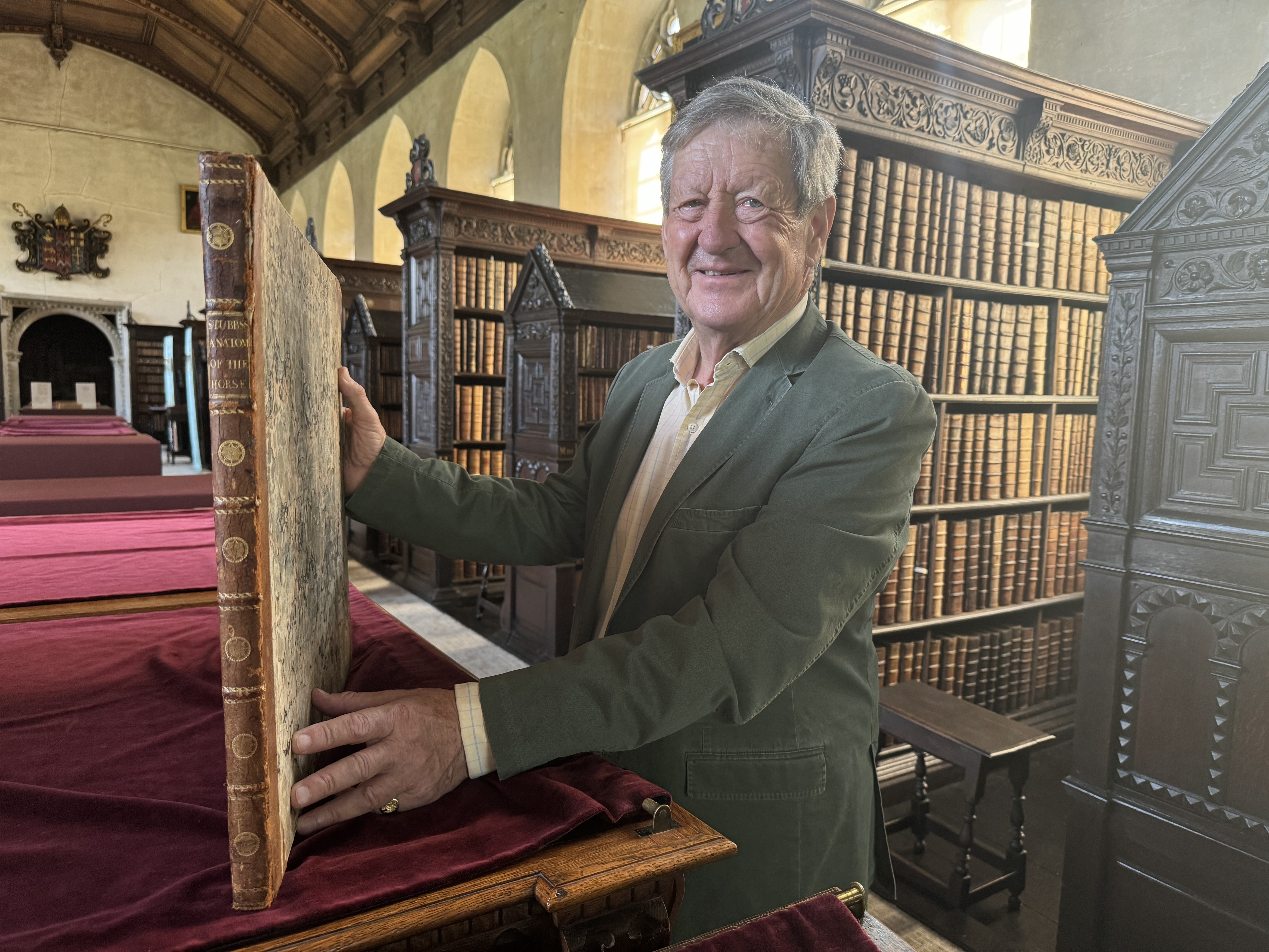 Philip Paxman with his book in the Old Library at St John's College, Cambridge