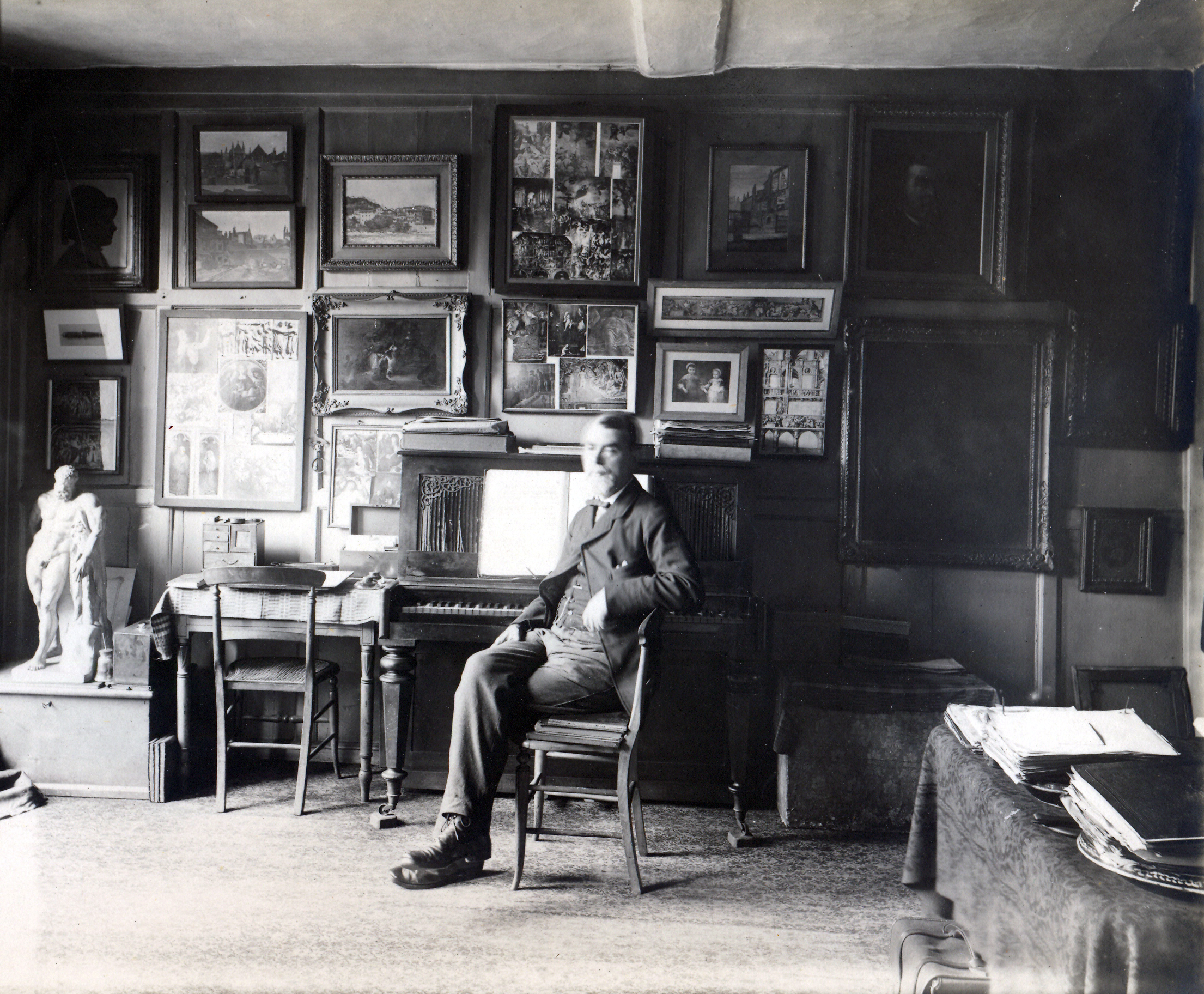 Butler at the piano, in his rooms at Clifford's Inn, London