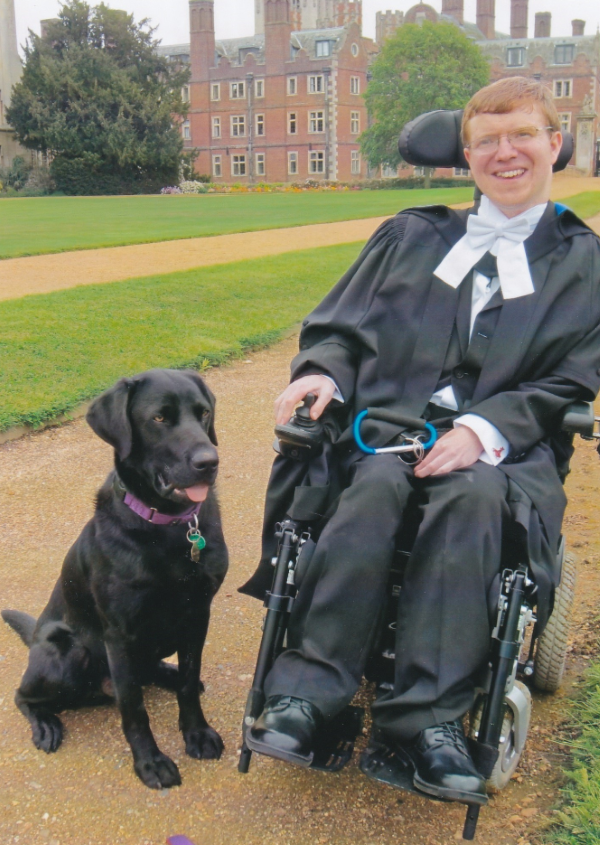 Jonathan at his MPhil graduation with his assistance dog, Uri