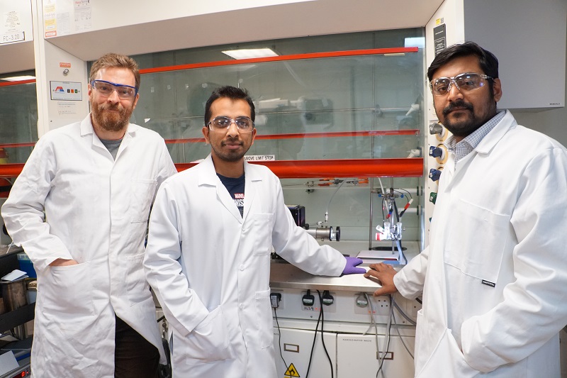 (From left) Professor Erwin Reisner, Subhajit Bhattacharjee and Dr Motiar Rahaman with the solar reactor that can simultaneously convert carbon dioxide into clean fuels and upcycle plastics into glycolic acid, a useful organic chemical for skincare creams