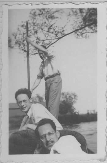 A black and white photo of three mathematicians in a punt