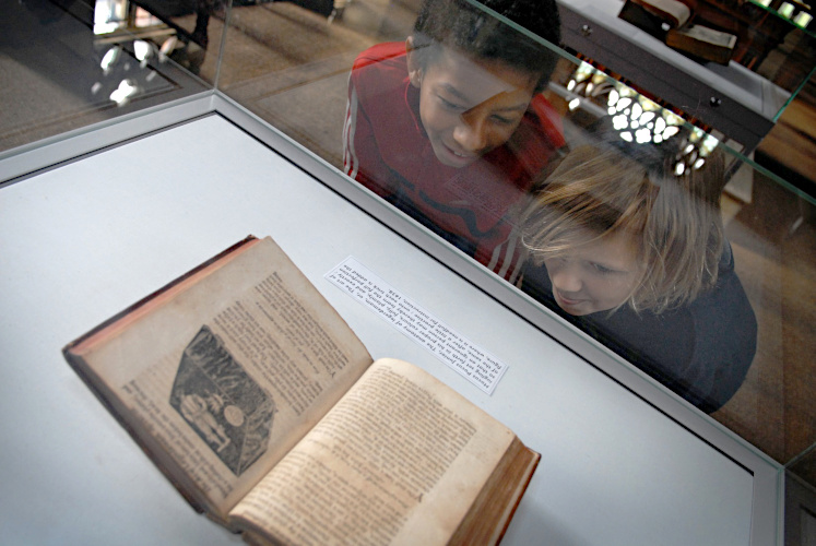 Photograph of primary school children examining an exhibit.