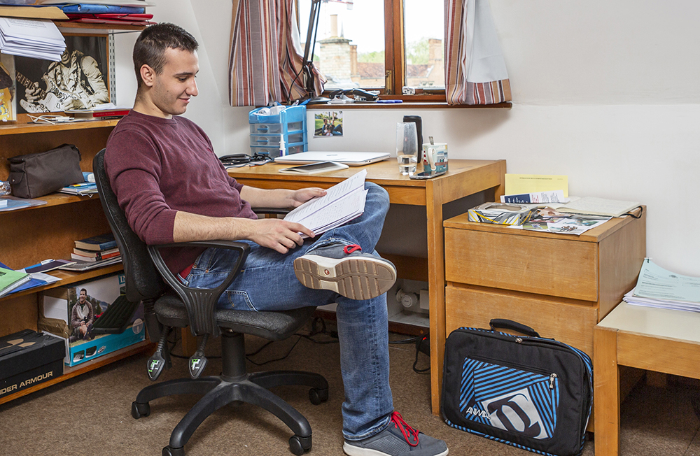 A student studies in his room