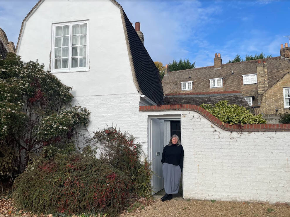 Vona outside Merton Hall Cottage longer shot