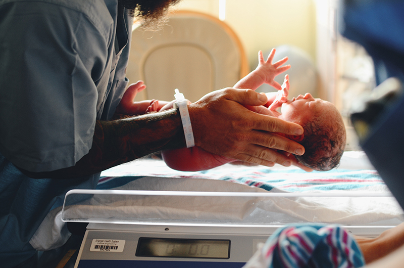 A newborn baby is weighed