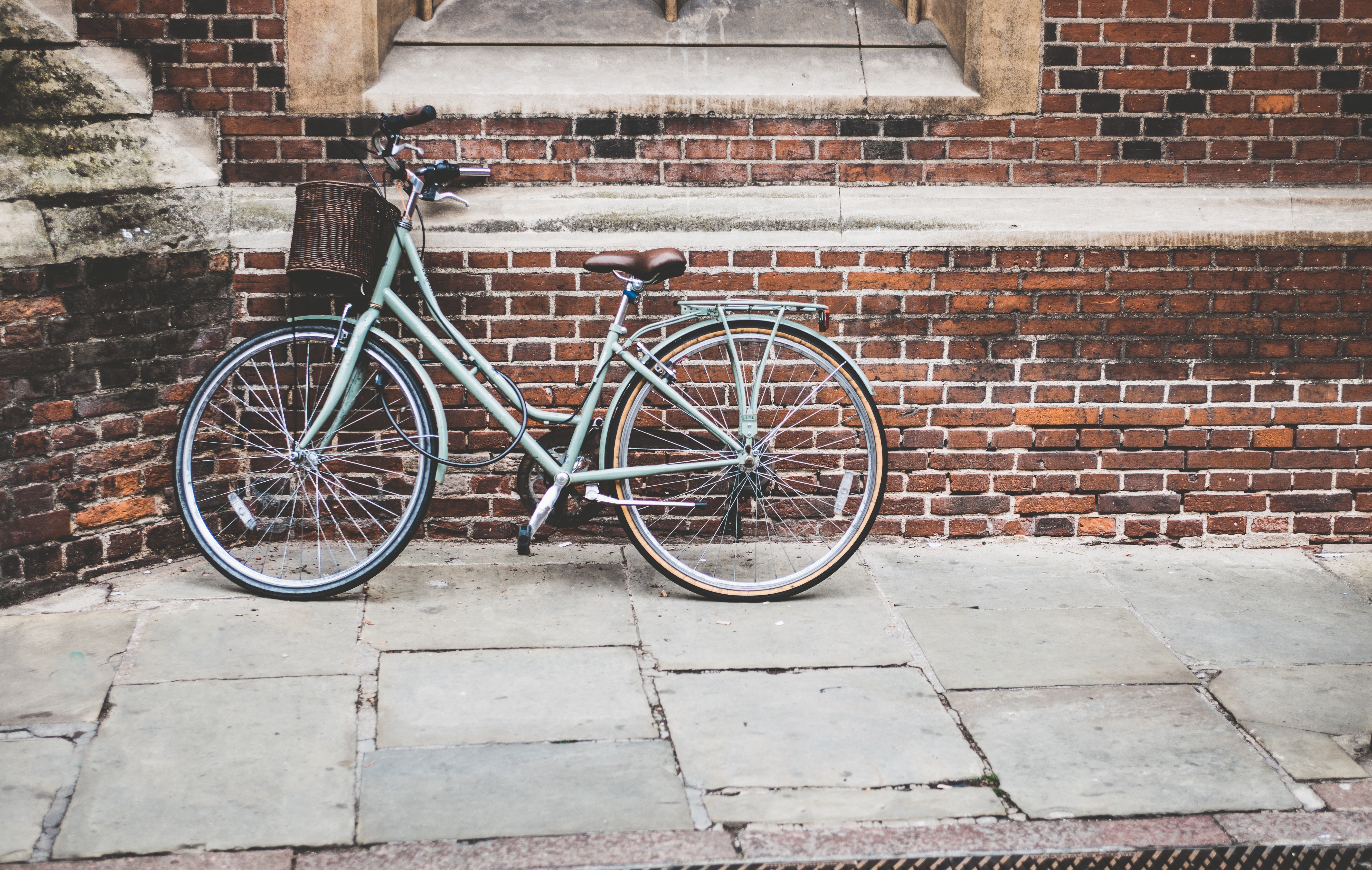 A bike leans against a wall