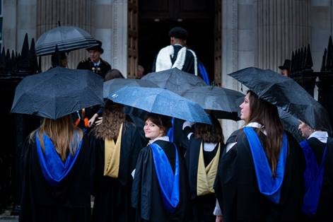 Graduates with umbrellas